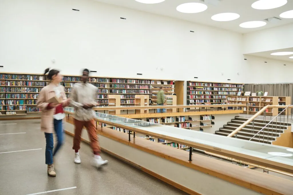 Students walking in a research library